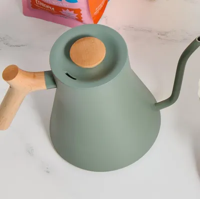 Fellow Stagg EKG Pro electric kettle in smoke green with a maple handle